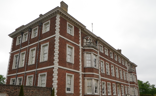 Big old house on a cloudy day taken from a side angle.