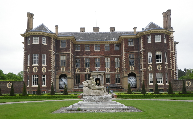 A big old house with gardens on a cloudy day